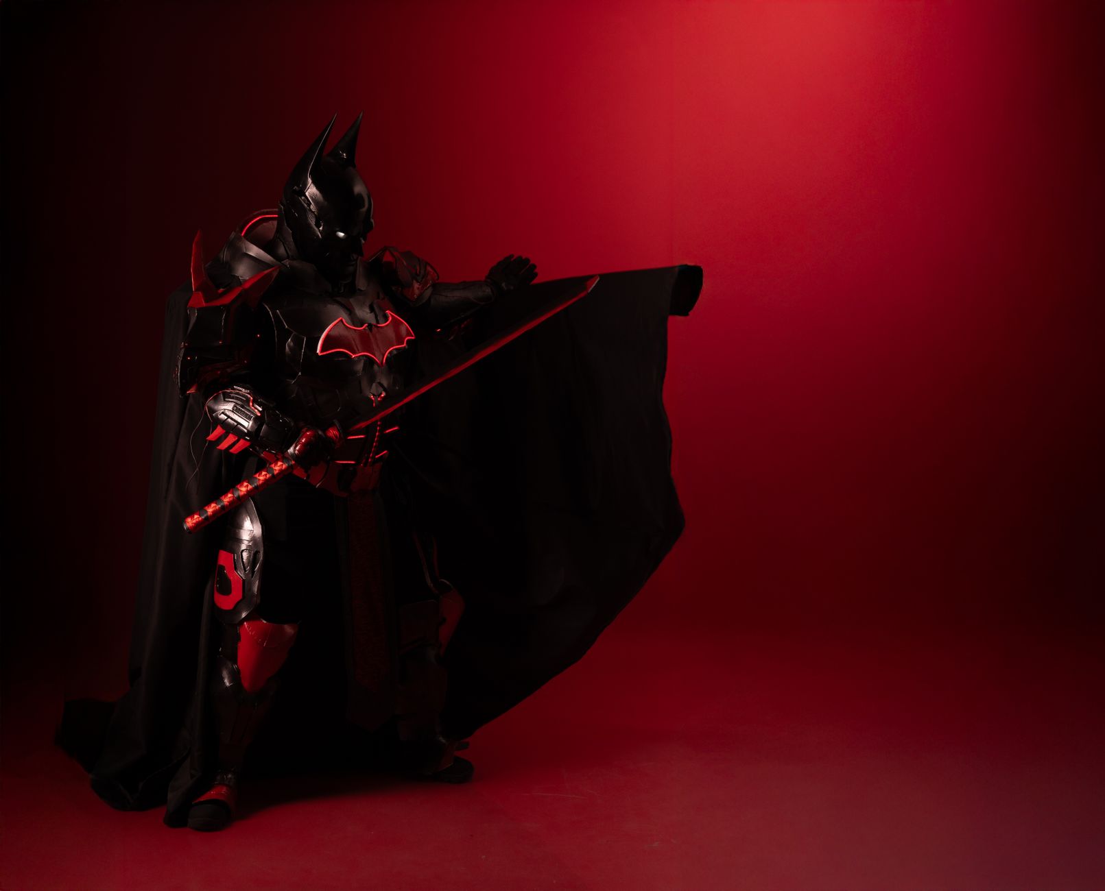 dramatic superhero cosplay with red and black costume