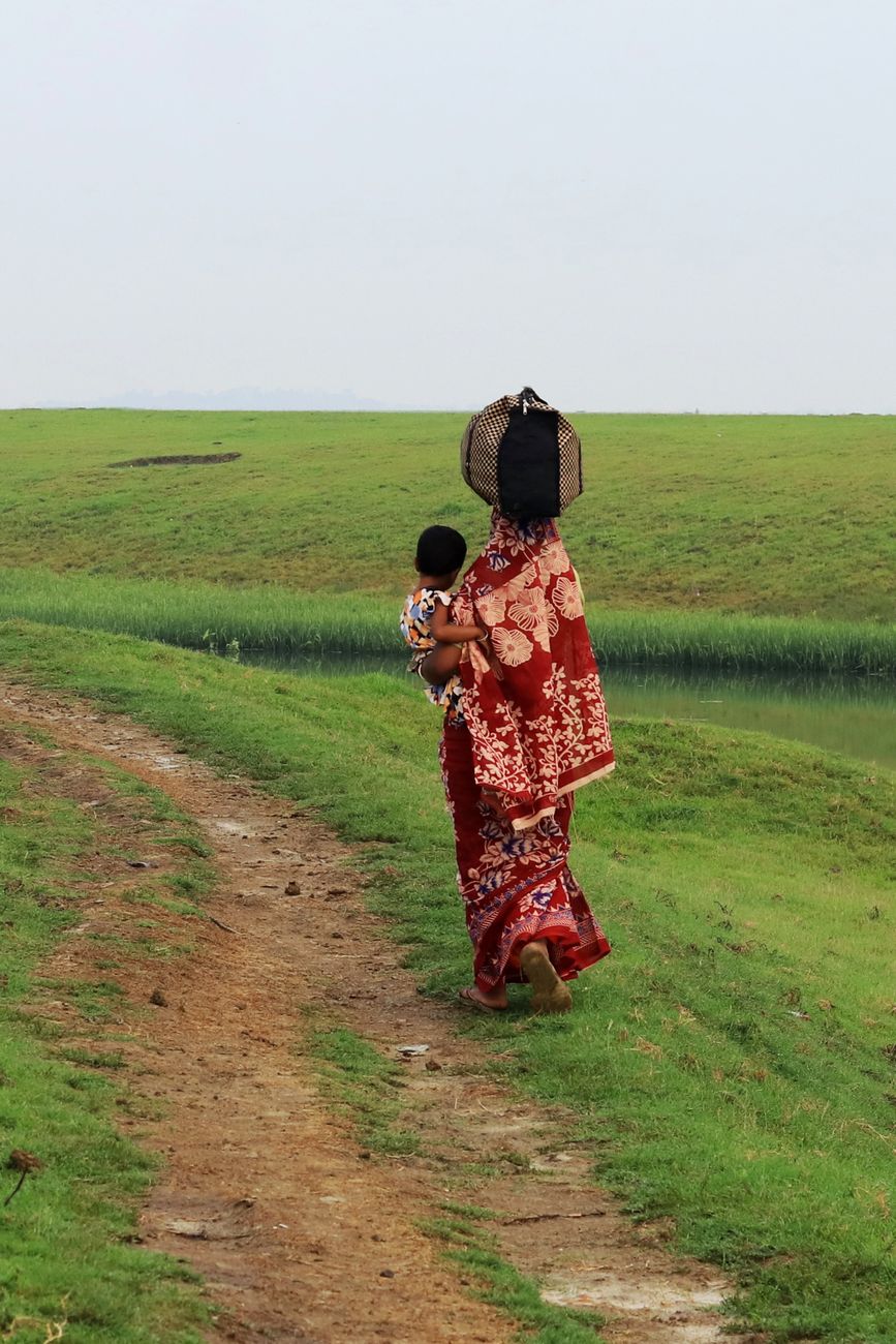 mother walking with child on rural path